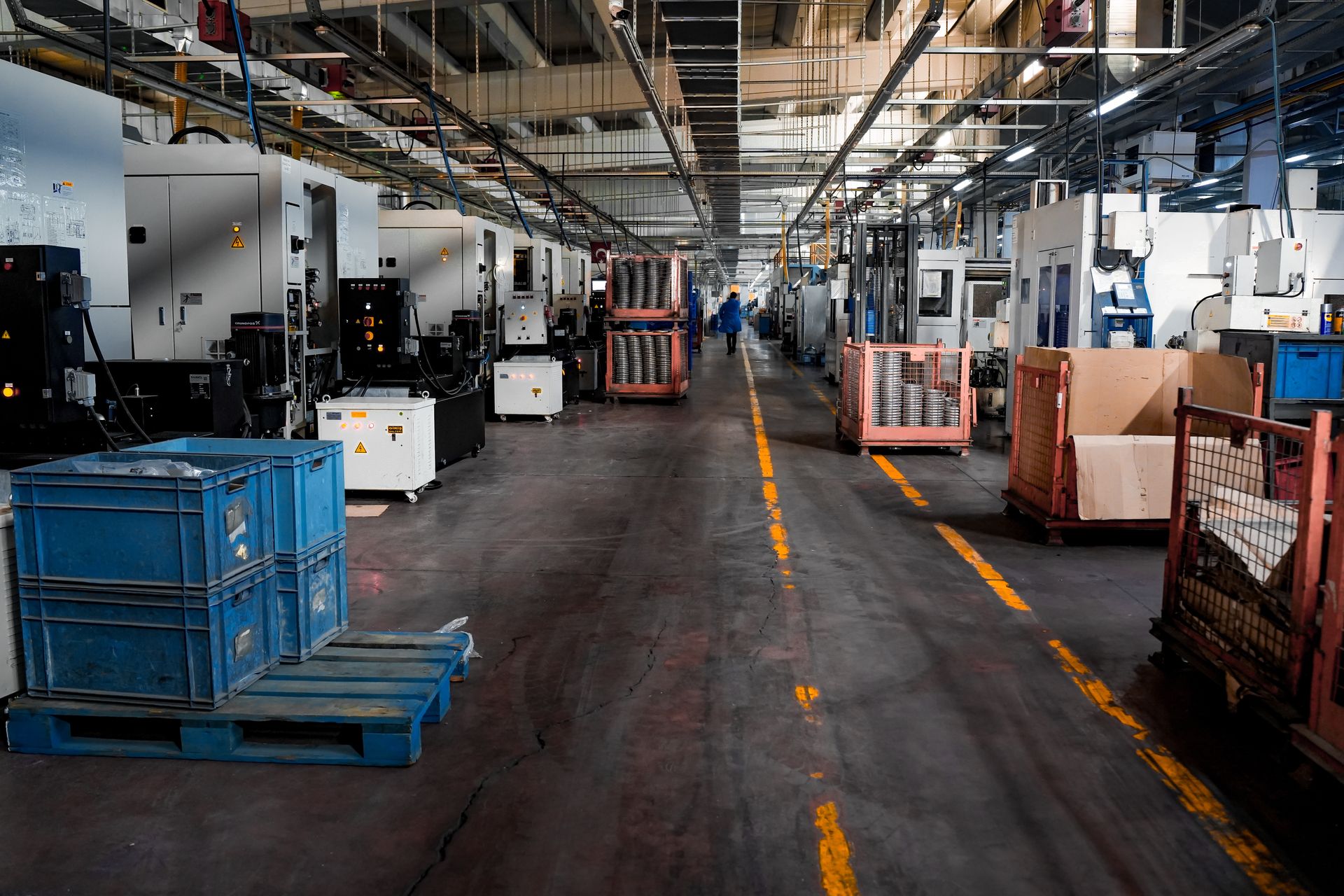Interior of a modern manufacturing facility with machinery lining the production floor