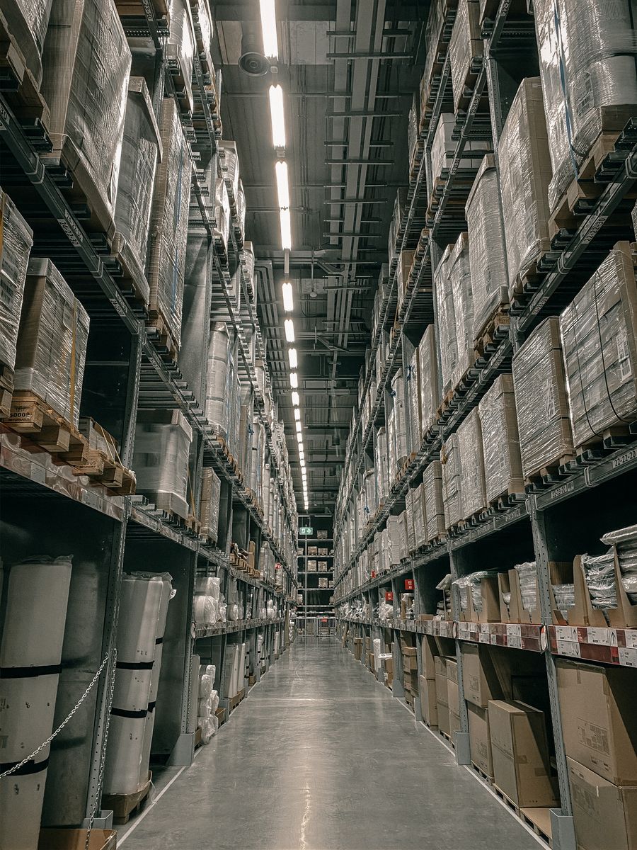 Tall organized warehouse racks stocked with palletized inventory